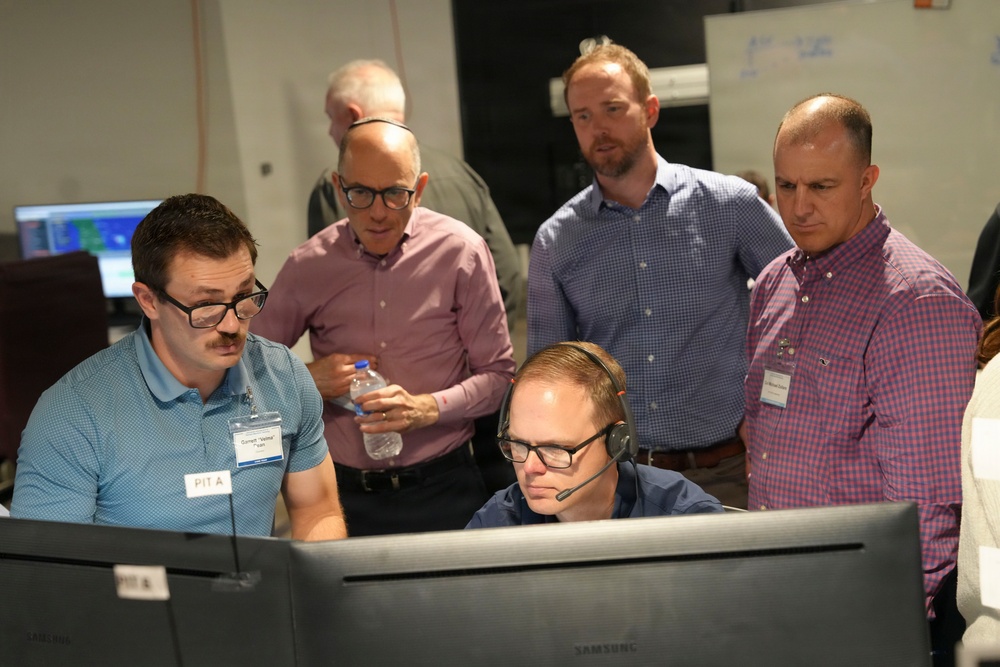 Participants examining digital displays during a human-machine teaming experiment